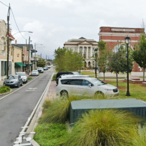 Jefferson Memorial in downtown Gretna with cars and shops along the street.