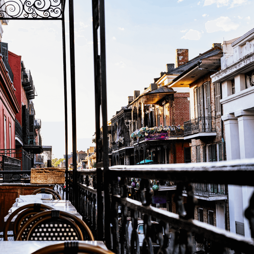 French Quarter balcony view in New Orleans with historic buildings and restaurants French Quarter balcony view in New Orleans with historic buildings and restaurants