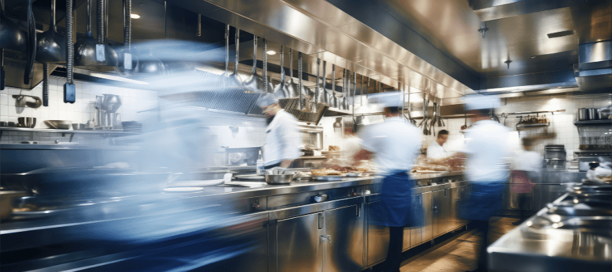 Chefs working in a busy commercial kitchen.
