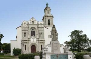 Historic church with statue and trees. Historic church with statue and trees.