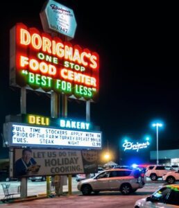 Neon-lit grocery store sign at night. Neon-lit grocery store sign at night.